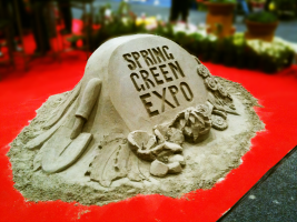 Spring Green Expo logo in sand.